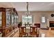 Classic dining room with an antique china cabinet, elegant chandelier, and a cozy fireplace at 2694 Sterling Dr, Lawrenceville, GA 30043