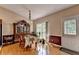 Traditional dining room featuring a glass table, antique hutch, and a door to the outside at 2694 Sterling Dr, Lawrenceville, GA 30043