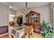 Dining area adjacent to the kitchen features an antique hutch, glass table, and access to the kitchen at 2694 Sterling Dr, Lawrenceville, GA 30043