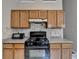 Kitchen with wood cabinets and tiled backsplash plus a view of the dining area at 2694 Sterling Dr, Lawrenceville, GA 30043