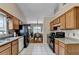 Bright kitchen with wood cabinets, stainless steel appliances, and a view to the dining room at 2694 Sterling Dr, Lawrenceville, GA 30043