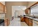 Open kitchen featuring wood cabinets, stainless steel appliances, and a view to a bright dining area at 2694 Sterling Dr, Lawrenceville, GA 30043
