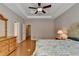 Stylish main bedroom boasts gleaming hardwood floors, tray ceilings, and ample closet space at 2694 Sterling Dr, Lawrenceville, GA 30043