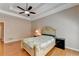Relaxing main bedroom featuring hardwood floors, tray ceilings, and ample closet space at 2694 Sterling Dr, Lawrenceville, GA 30043