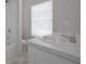 Bright bathroom featuring a single sink vanity with a wide window and marble countertop at 48 Deer Pl, Villa Rica, GA 30180