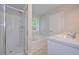 Bathroom features a glass-enclosed shower, tub, and double sink vanity with bright window at 48 Deer Pl, Villa Rica, GA 30180