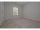 An empty bedroom features plush carpeting, a bright window, and fresh, neutral paint at 48 Deer Pl, Villa Rica, GA 30180