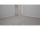 An empty bedroom features plush carpeting, a bright window, and fresh, neutral paint at 48 Deer Pl, Villa Rica, GA 30180