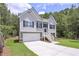 Charming two-story home featuring a two-car garage and inviting front porch at 48 Deer Pl, Villa Rica, GA 30180