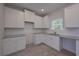 Modern kitchen boasts white cabinets, stainless steel sink, and granite countertops at 48 Deer Pl, Villa Rica, GA 30180