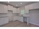 Modern kitchen boasts white cabinets, stainless steel sink, and granite countertops at 48 Deer Pl, Villa Rica, GA 30180