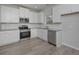 Modern kitchen featuring white cabinetry, stainless steel appliances, and granite countertops at 48 Deer Pl, Villa Rica, GA 30180