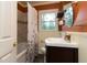 Cozy bathroom with a bathtub, shower curtain, and a vanity with a sink at 2118 Allaire Ne Ln, Atlanta, GA 30345
