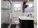 Bathroom with a glass shower, vanity with a modern faucet, and decorative shelves at 2118 Allaire Ne Ln, Atlanta, GA 30345