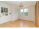 Bedroom area featuring wood floor, ample closet space, a view to outdoors, and designer lighting at 2118 Allaire Ne Ln, Atlanta, GA 30345