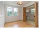 Bedroom area featuring wood floors, ample closet space, and a view to outdoors at 2118 Allaire Ne Ln, Atlanta, GA 30345