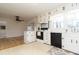 Kitchen featuring white cabinets, black appliances, and a view into the living room at 2118 Allaire Ne Ln, Atlanta, GA 30345