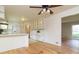 Open kitchen with white cabinetry, a breakfast bar, hardwood floors, and modern appliances at 2118 Allaire Ne Ln, Atlanta, GA 30345