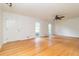 Spacious living room with hardwood floors, two windows, and a ceiling fan at 2118 Allaire Ne Ln, Atlanta, GA 30345