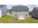 Backyard features a grassy yard, patio, and neutral gray siding at 215 Amberjack Trail, Covington, GA 30016