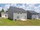 A large backyard featuring neutral siding, patio area and green grass at 215 Amberjack Trail, Covington, GA 30016