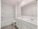 Bright bathroom features double sink vanity, large mirror, and tub shower combo at 215 Amberjack Trail, Covington, GA 30016