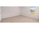 Bright bedroom with a large window offering ample natural light and neutral colored carpeting at 215 Amberjack Trail, Covington, GA 30016