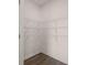 Walk-in closet with shelving and neutral colored wood floors at 215 Amberjack Trail, Covington, GA 30016