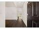 Inviting entryway showcasing modern wood floors, and a glimpse into the open-concept living space at 215 Amberjack Trail, Covington, GA 30016