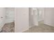 Hallway leading to bathroom and bedrooms with white paint, neutral carpet and vinyl flooring at 215 Amberjack Trail, Covington, GA 30016