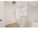 Hallway featuring neutral paint, carpet, and white doors with an open view into other rooms at 215 Amberjack Trail, Covington, GA 30016