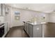Kitchen with granite counters, stainless appliances, grey cabinets, wood floors, and access to the living room at 215 Amberjack Trail, Covington, GA 30016