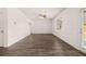 Open-concept living room with wood floors, large windows, and access to outdoor space at 215 Amberjack Trail, Covington, GA 30016
