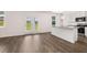 Open-concept living room boasts modern wood flooring and double doors to the backyard at 215 Amberjack Trail, Covington, GA 30016