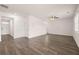 Expansive living room with wood floors, neutral walls, recessed lighting, and multiple entryways at 215 Amberjack Trail, Covington, GA 30016