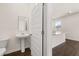The home features a convenient powder room with pedestal sink and stylish finishes at 215 Amberjack Trail, Covington, GA 30016