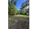 Expansive backyard with lush green grass and mature trees for privacy and shade at 5142 Fawn Sw Ln, Conyers, GA 30094