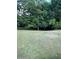 Picture of the large backyard and lush greenery in a wooded area at 5142 Fawn Sw Ln, Conyers, GA 30094