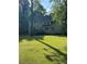 Large backyard with grass and trees and a view of the house and deck at 5142 Fawn Sw Ln, Conyers, GA 30094