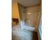 Bathroom showing a bathtub with shower and tile accents at 5142 Fawn Sw Ln, Conyers, GA 30094