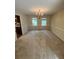 Formal dining room with elegant chandelier and large windows, perfect for gatherings at 5142 Fawn Sw Ln, Conyers, GA 30094