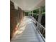 Wide porch featuring classic white railings, brick accents, and views of the surrounding greenery at 5142 Fawn Sw Ln, Conyers, GA 30094