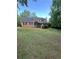 Traditional two-story home featuring a well-manicured front yard and mature trees at 5142 Fawn Sw Ln, Conyers, GA 30094