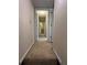Hallway with carpet leading to rooms and an open doorway at 5142 Fawn Sw Ln, Conyers, GA 30094