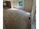 Bright living room with plush carpeting and large windows, filling the space with natural light at 5142 Fawn Sw Ln, Conyers, GA 30094