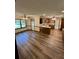 Spacious open floor plan between the kitchen and living room with new wood-look flooring at 5142 Fawn Sw Ln, Conyers, GA 30094