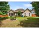 Spacious backyard with established landscaping and a screened porch at 7994 Larksview Dr, Fairburn, GA 30213