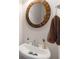 Close up on bathroom featuring an oval mirror, sleek sink and countertop at 7994 Larksview Dr, Fairburn, GA 30213