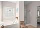 Bathroom with a soaking tub under a decorative window and a glass enclosed shower at 7994 Larksview Dr, Fairburn, GA 30213