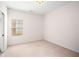 Bright bedroom with plush carpet and view of the landscaped yard at 7994 Larksview Dr, Fairburn, GA 30213